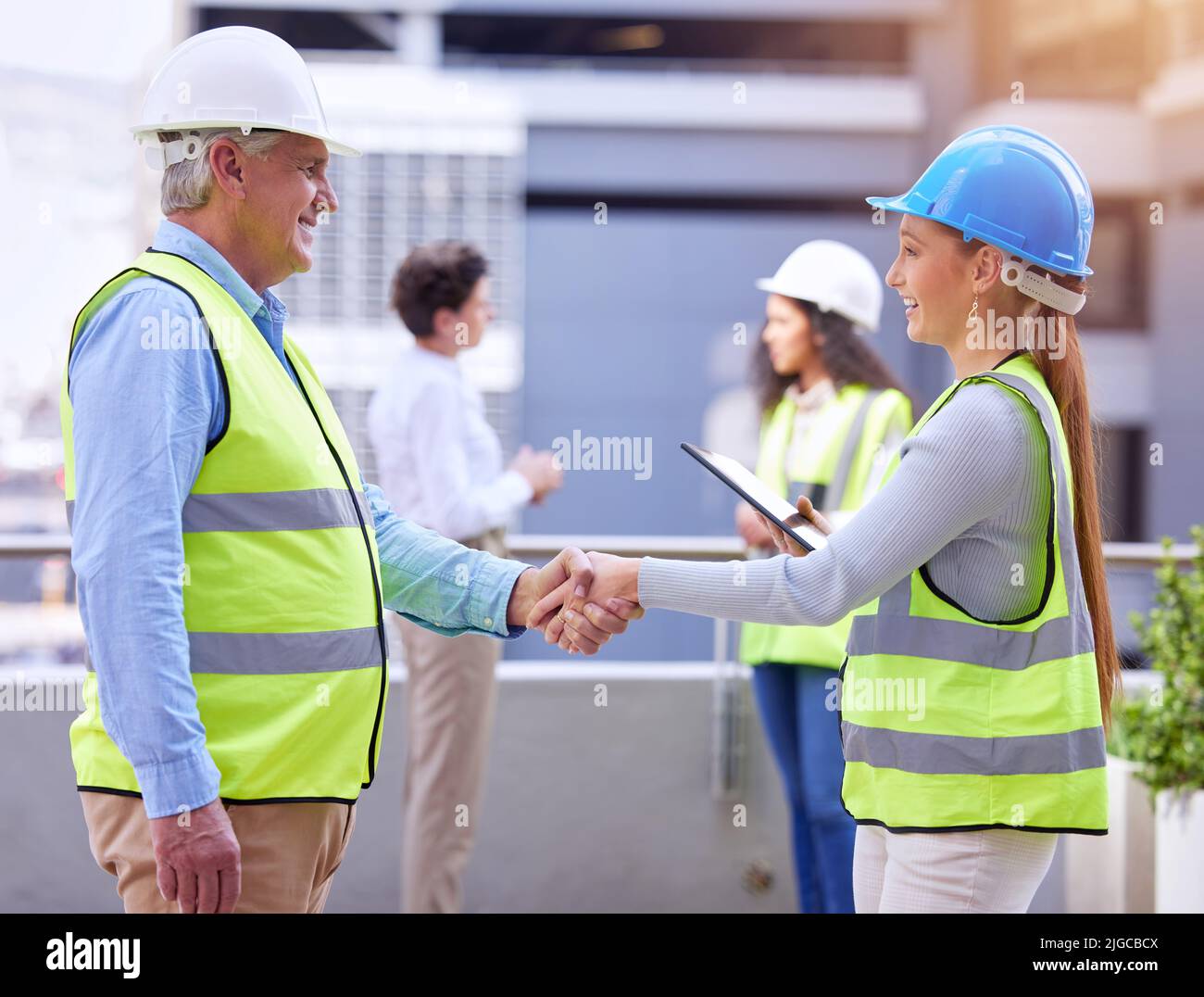 Ready for the electrical. two construction workers shaking hands while
