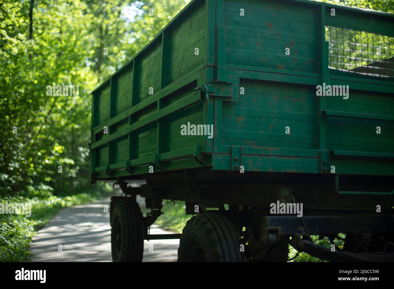 Green tractor trailer. Cart on wheels. Side of trailer. Body of
