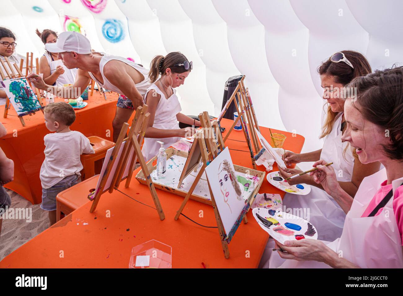 Miami Beach Florida,Ocean Terrace Fire on the Fourth 4th of July Festival event celebration,arts & crafts tent painting family families activity,woman Stock Photo