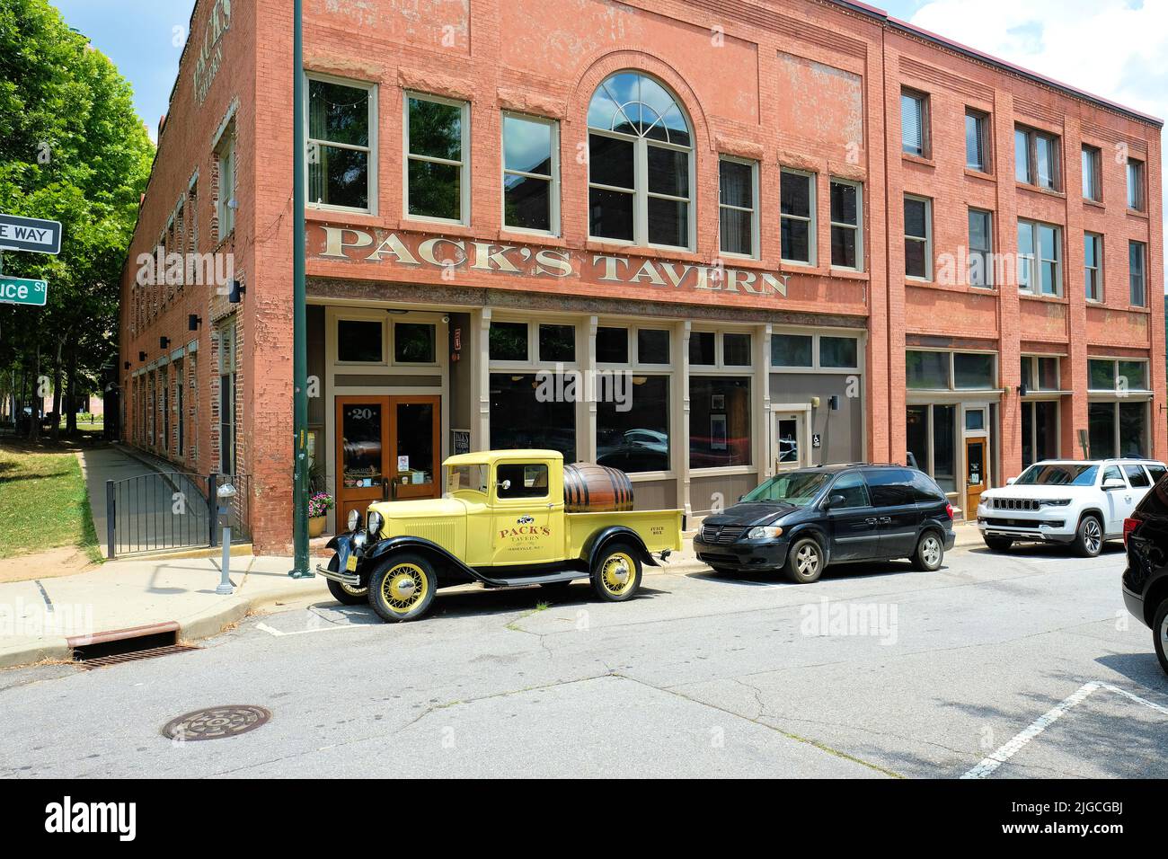 Pack's Tavern, next to Pack Square Park in downtown Asheville, North Carolina; bar, restaurant, dining; old yellow Ford pick up truck out front. Stock Photo