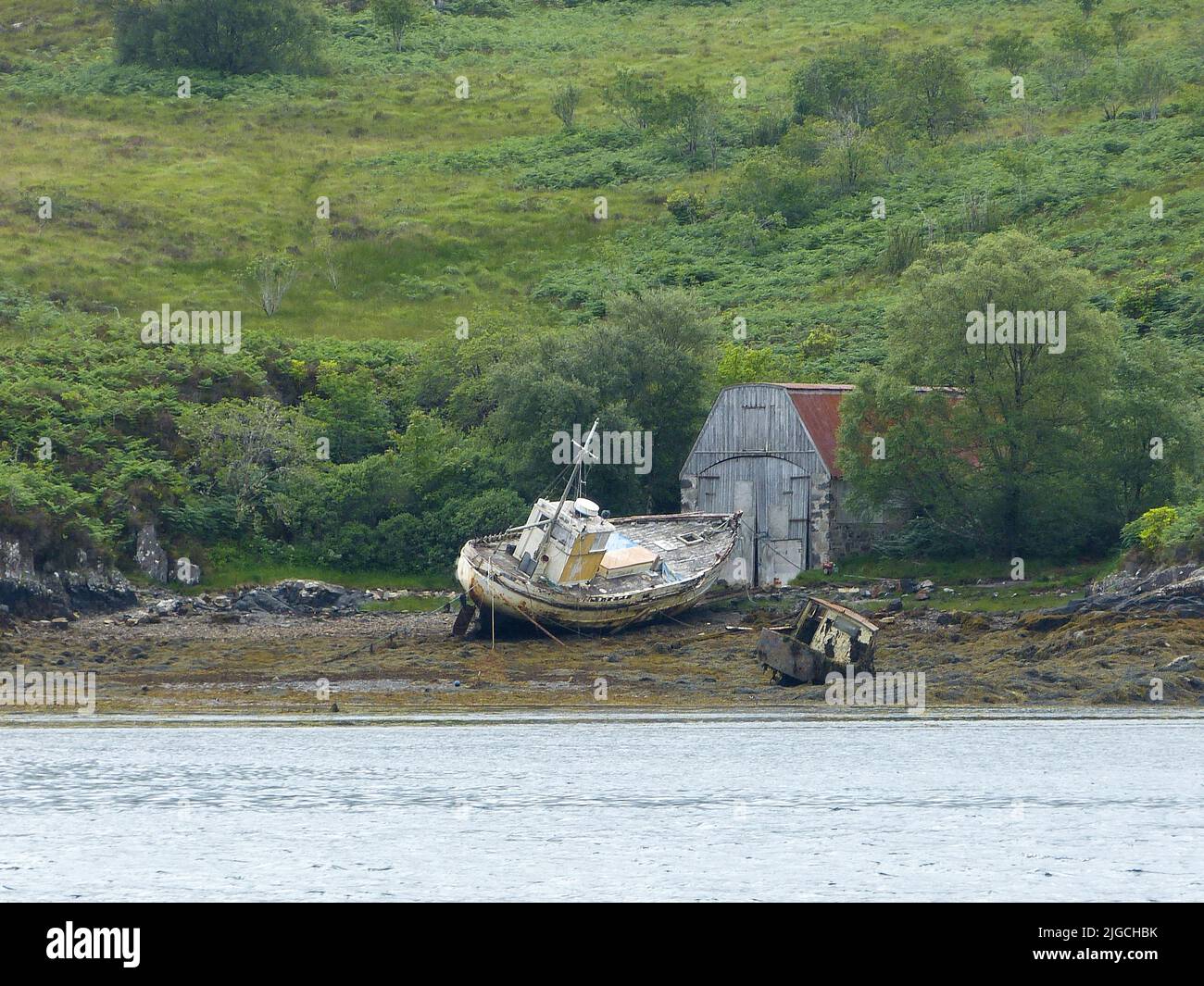 two old shipwrecks at low tide in Scotland Stock Photo