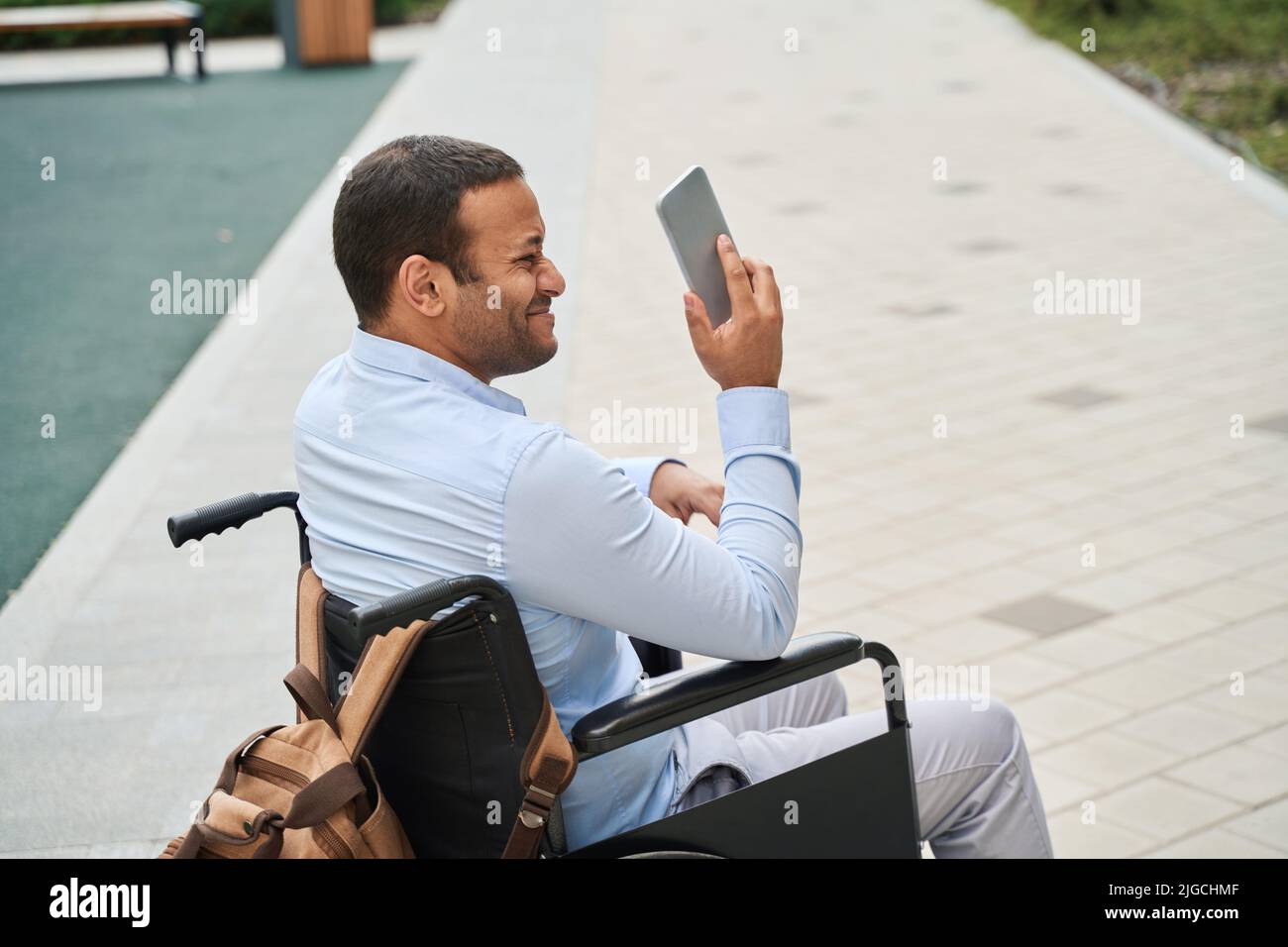 Male person with disability taking selfies outdoors Stock Photo