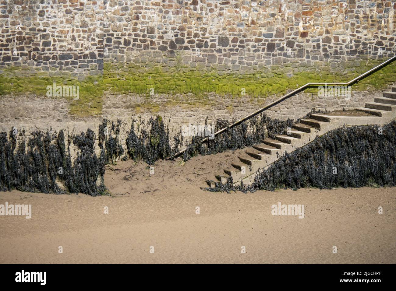 Steps to the water, low tide with seaweed. North Devon coast. Stock Photo