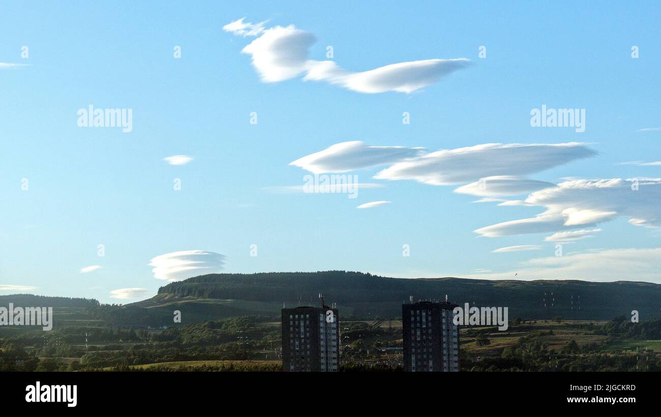 Glasgow, Scotland, UK 9th July, 2022.Spectacular UFO cloud invasion from loch lomond direction over bearsden towards the city as the lenticular clouds formed over hills and responsible for many spacecraft sightings appeared in the northern sky. Credit Gerard Ferry/Alamy Live News Stock Photo