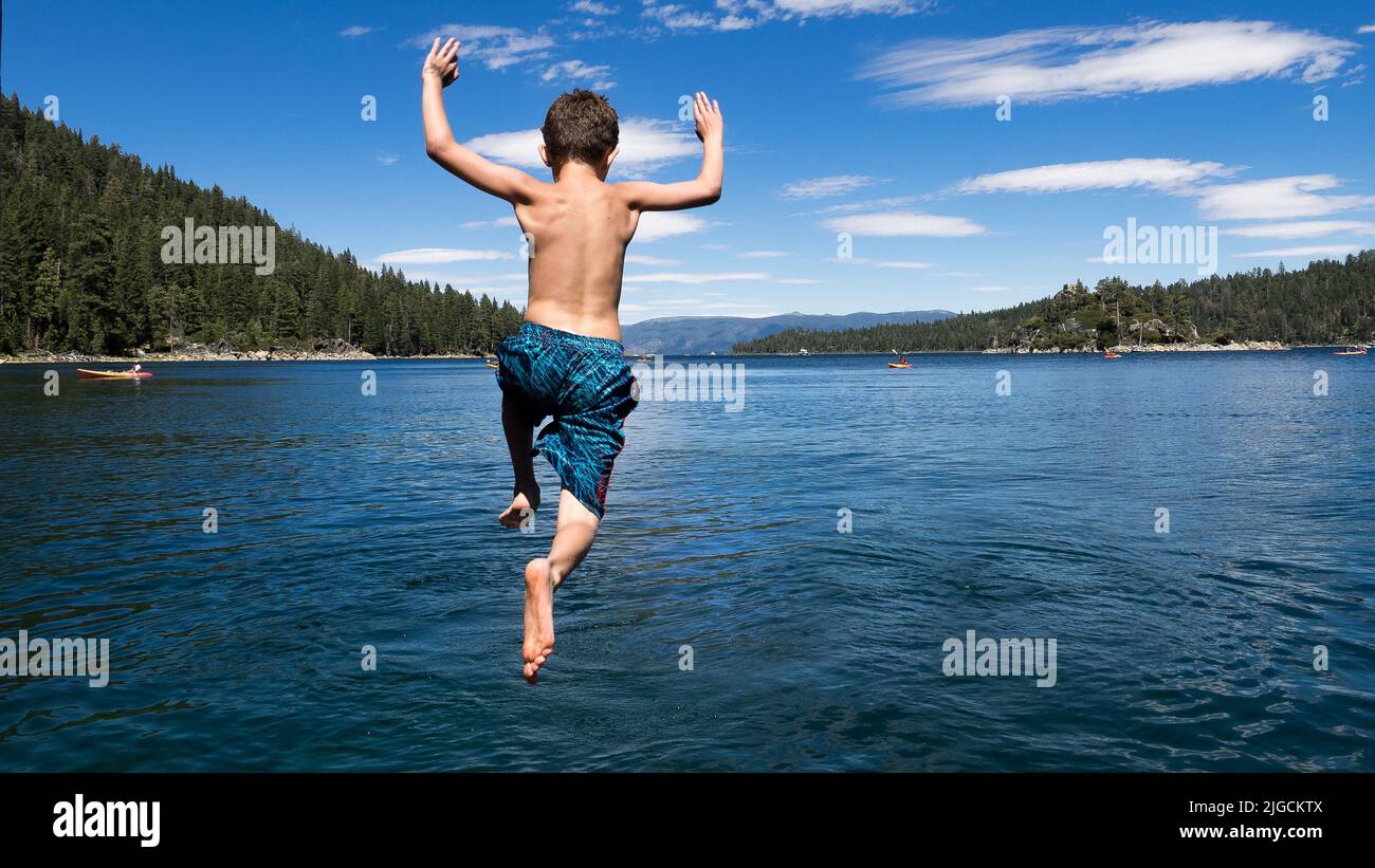 Boy jumping into lake hi-res stock photography and images - Alamy
