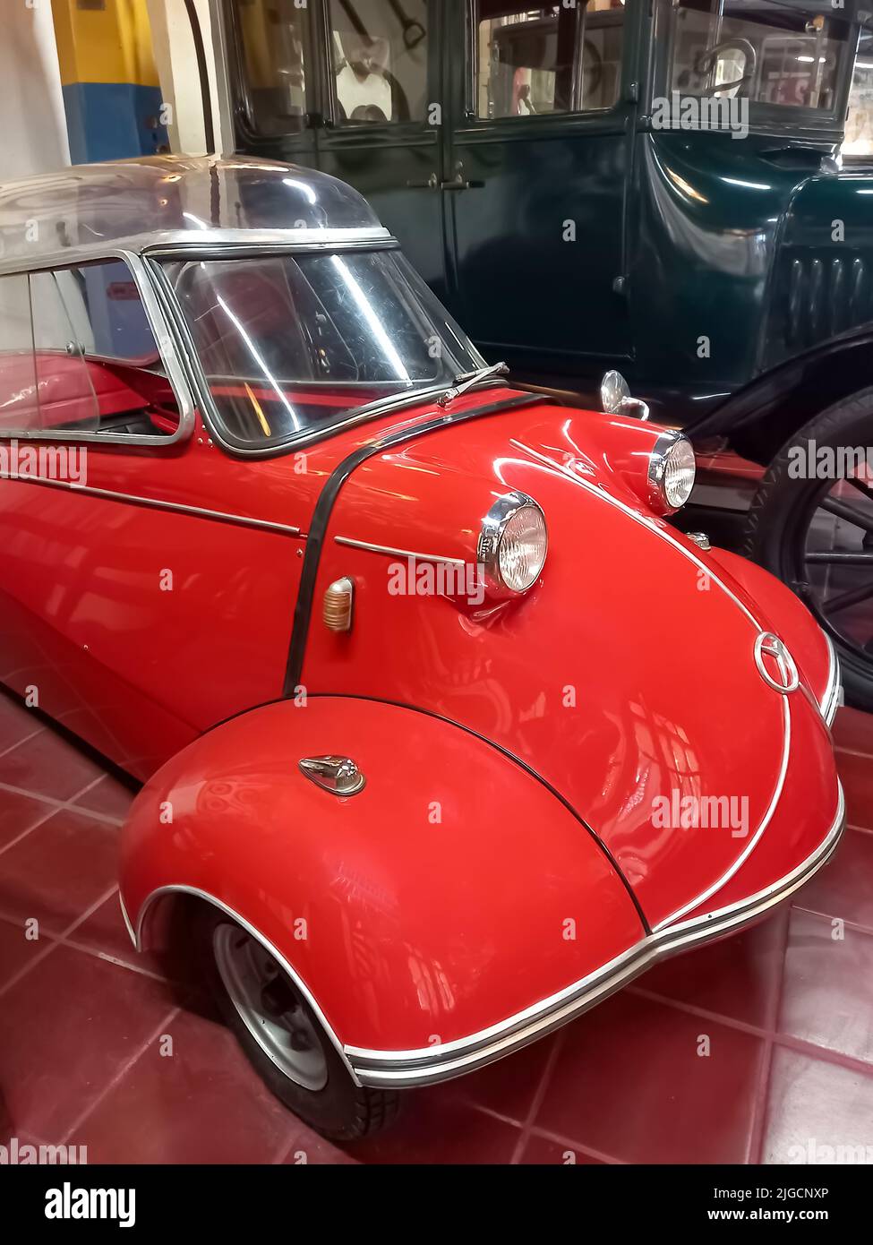 Old classic red economy Messerschmitt KR200 Kabinenroller 1959 coupe one door three wheel German micro car. Automobile Museum. Rau Collection. Stock Photo