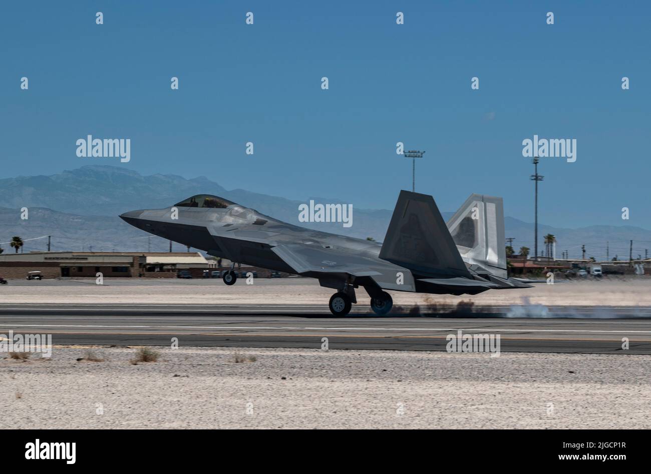 An F-22 Raptor assigned to Joint Base Langley-Eustis, Virginia arrives for Red Flag-Nellis 22-3 at Nellis Air Force Base, Nevada, July 6, 2022. Participants conduct a variety of scenarios, including defensive counter air, offensive counter air suppression of enemy air defenses and offensive counter air-air interdiction. (U.S. Air Force photo by William R. Lewis) Stock Photo