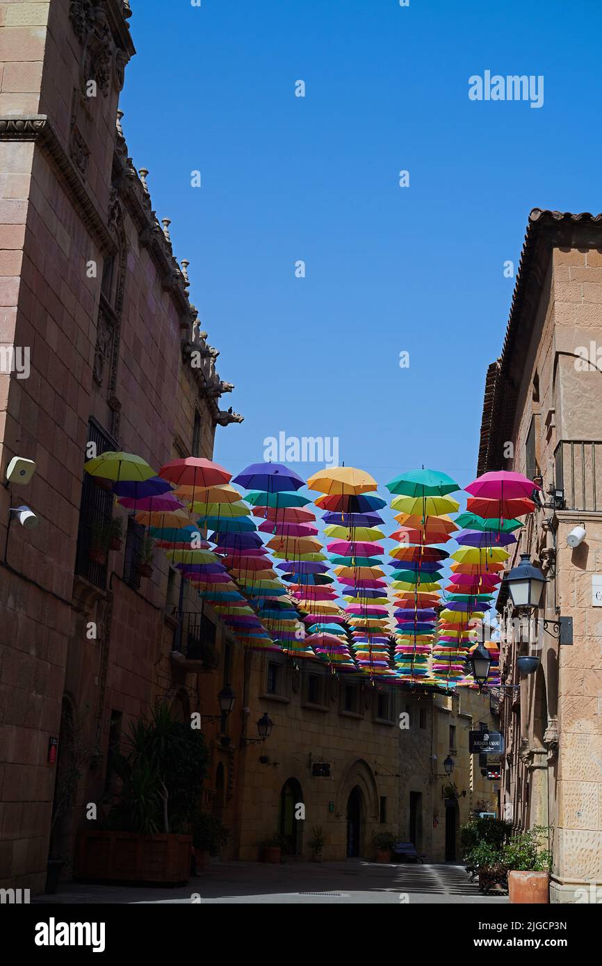 Beautiful coluorful umbrellas hanging across a typical street in the