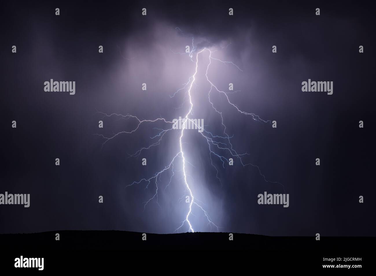 A lightning bolt strikes in a monsoon thunderstorm near Kearny, Arizona Stock Photo