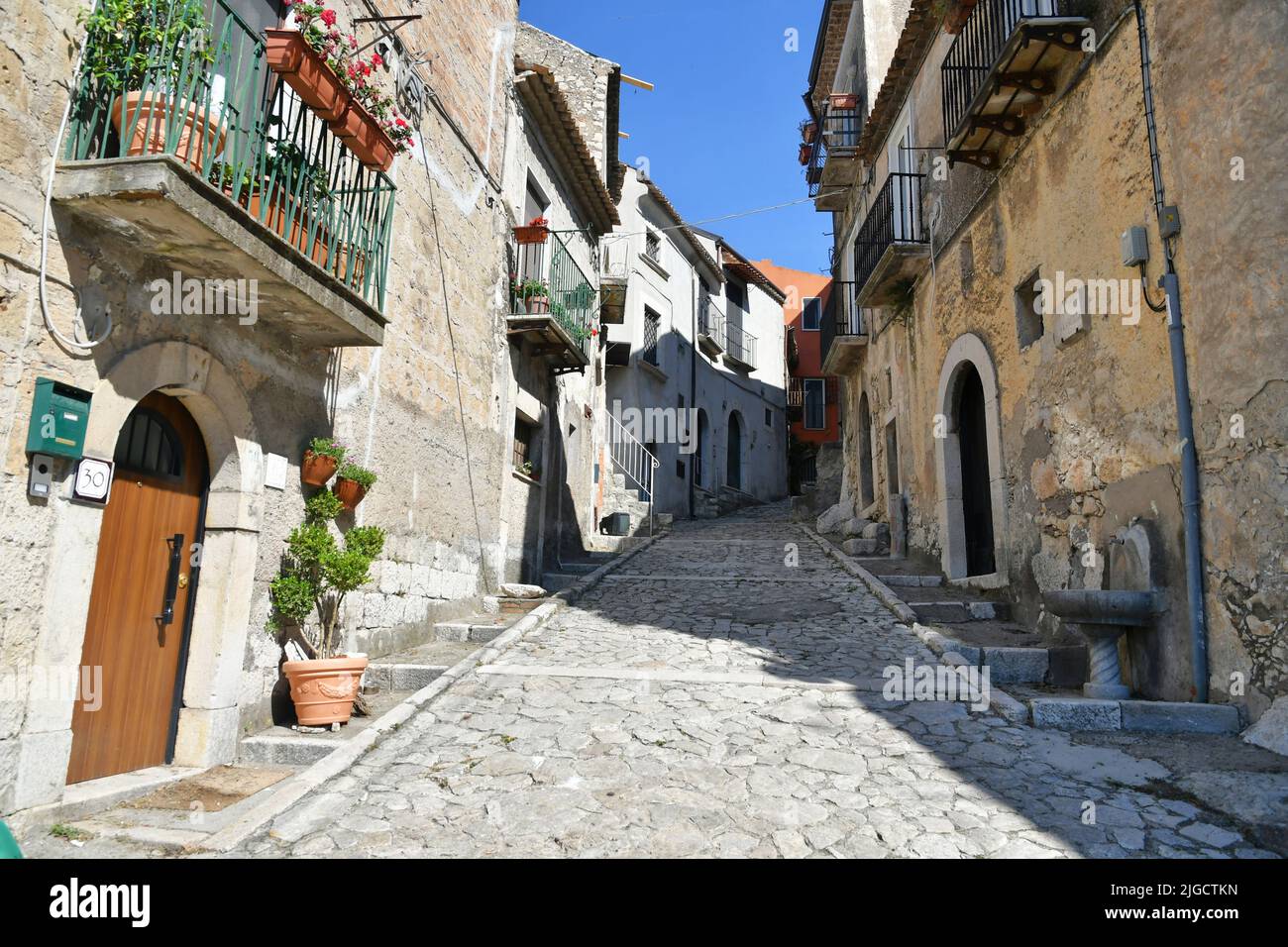 A narrow street between the old houses of Guardia Sanframondi, a