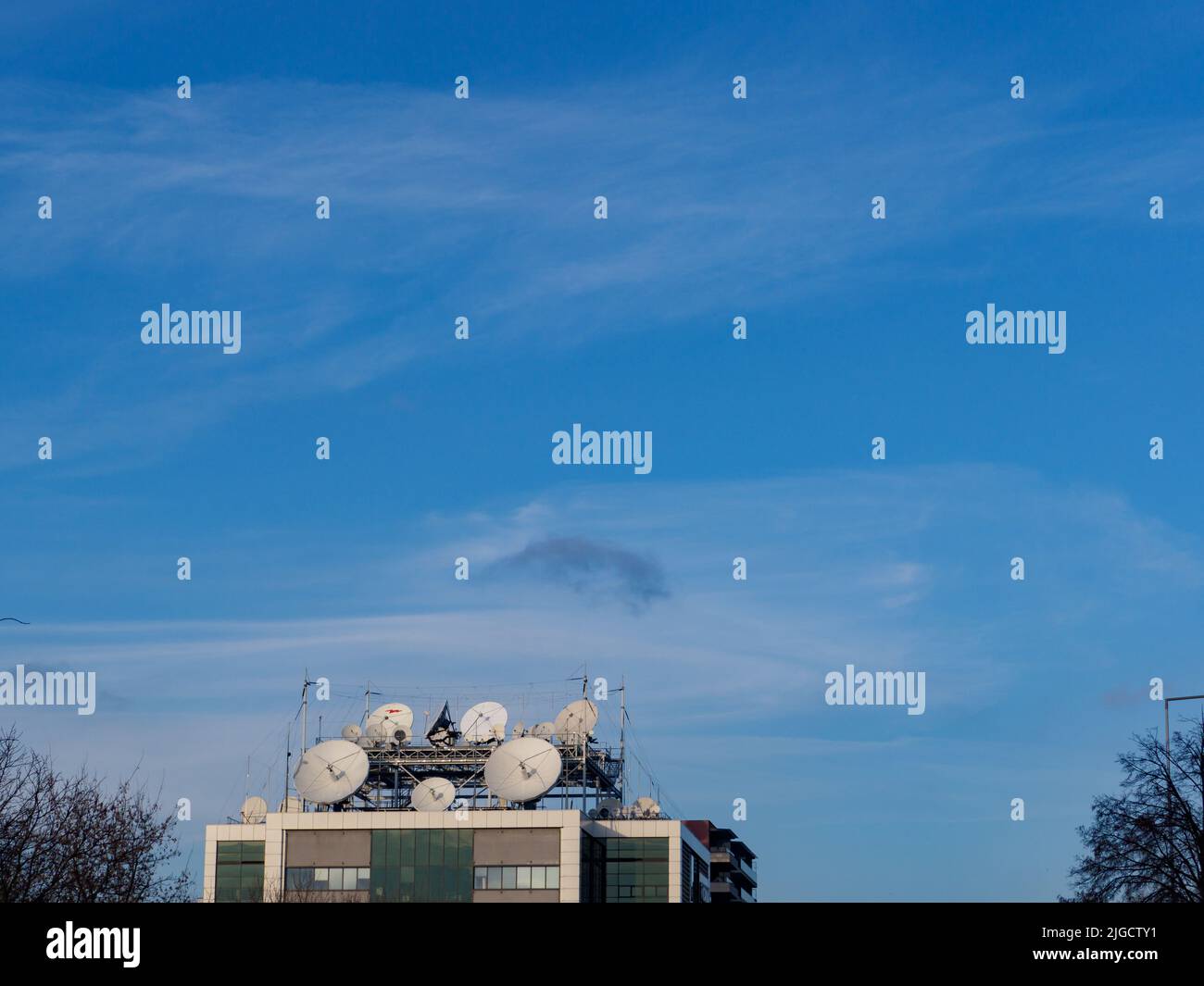 Satellite dishes against the background of blue sky Stock Photo
