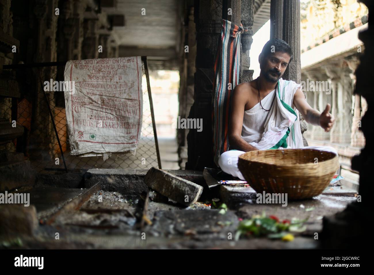 A selective focus of a hindu priest in pure hindu attire at Virupaksha Temple. Stock Photo