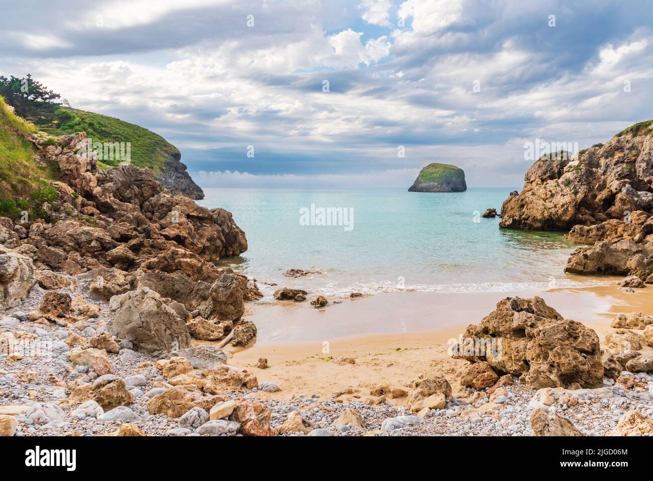 Troenzo beach, in the town of Celorio, a beach that becomes a small cove with the rising tide, Llanes. Stock Photo