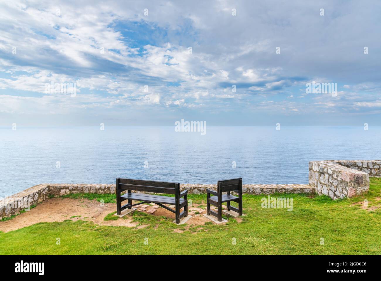 Benches on the Paseo de San Pedro, Llanes, with views of the Cantabrian Sea. Stock Photo
