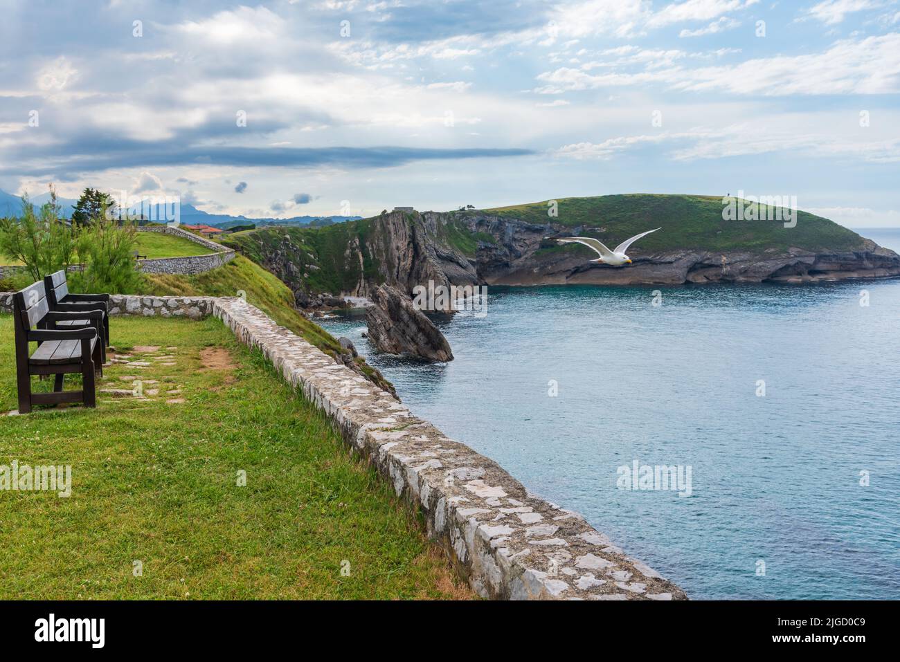 Bench on the Paseo de San Pedro, Llanes, overlooking the cliffs in the Cantabrian Sea. Stock Photo
