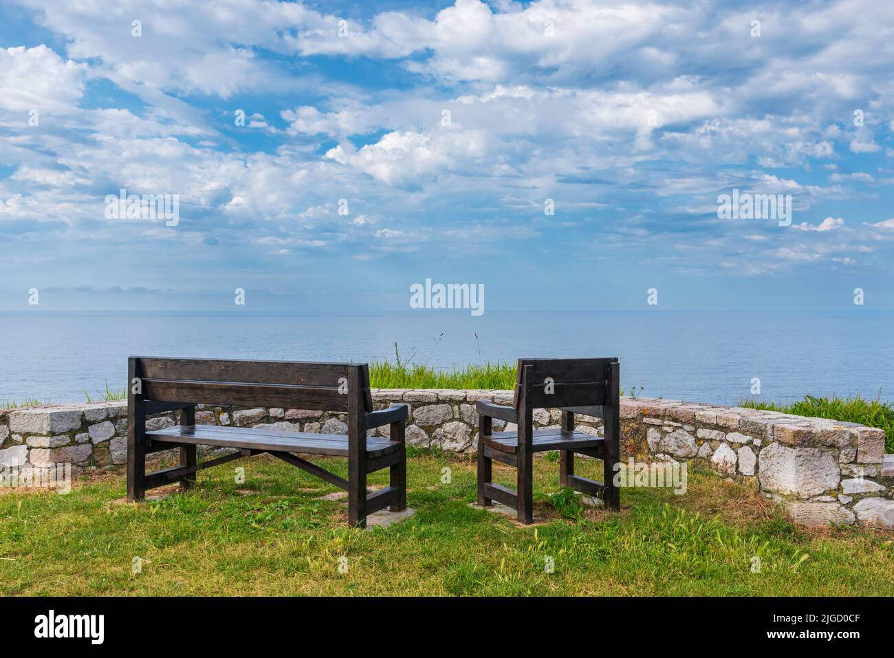 Benches on the Paseo de San Pedro, Llanes, with views of the Cantabrian Sea. Stock Photo