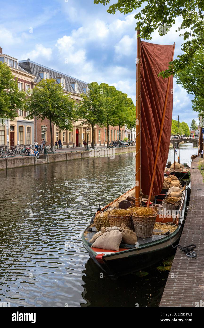 Historic wooden boat moored on Rapenburg canal, Leiden, South Holland, Netherlands  Reenactment festival of Rembrandt van Rijn, his paintings and era. Stock Photo