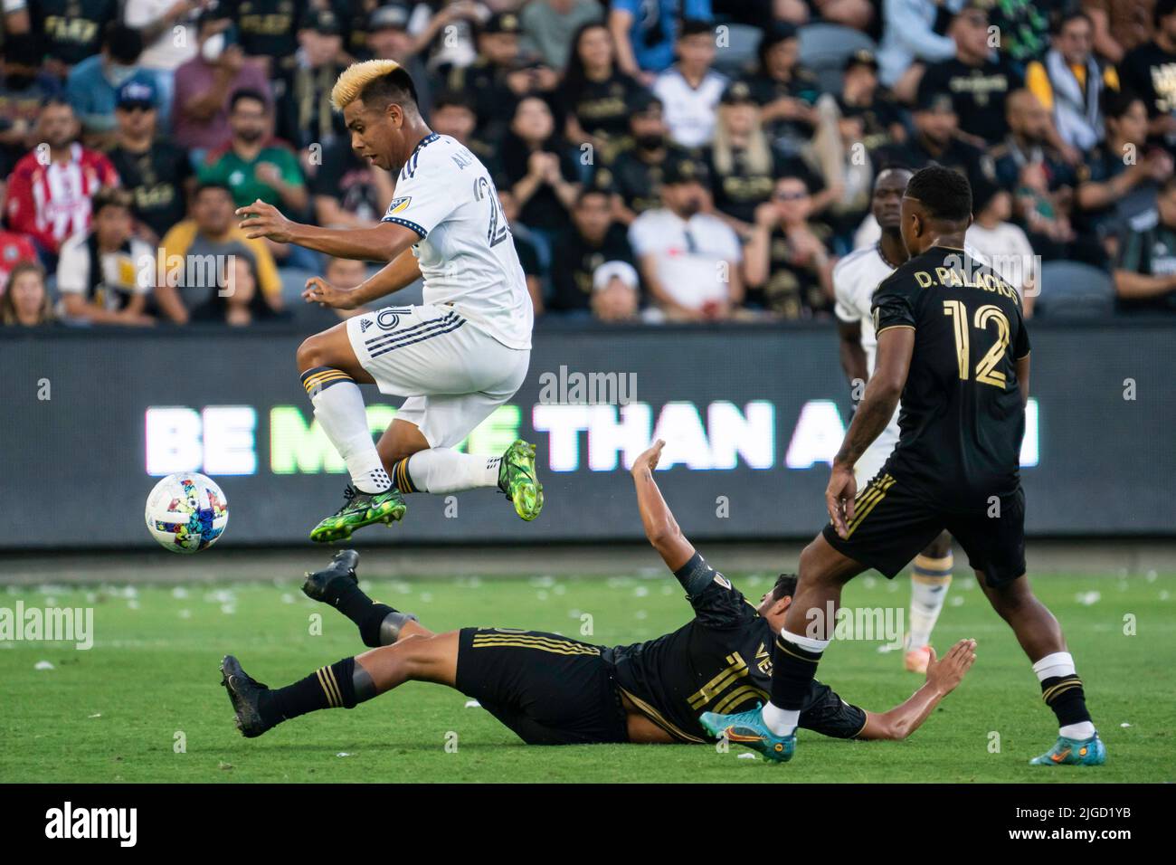 LA Galaxy midfielder Efrain Alvarez (26)avoids a slide tackle by