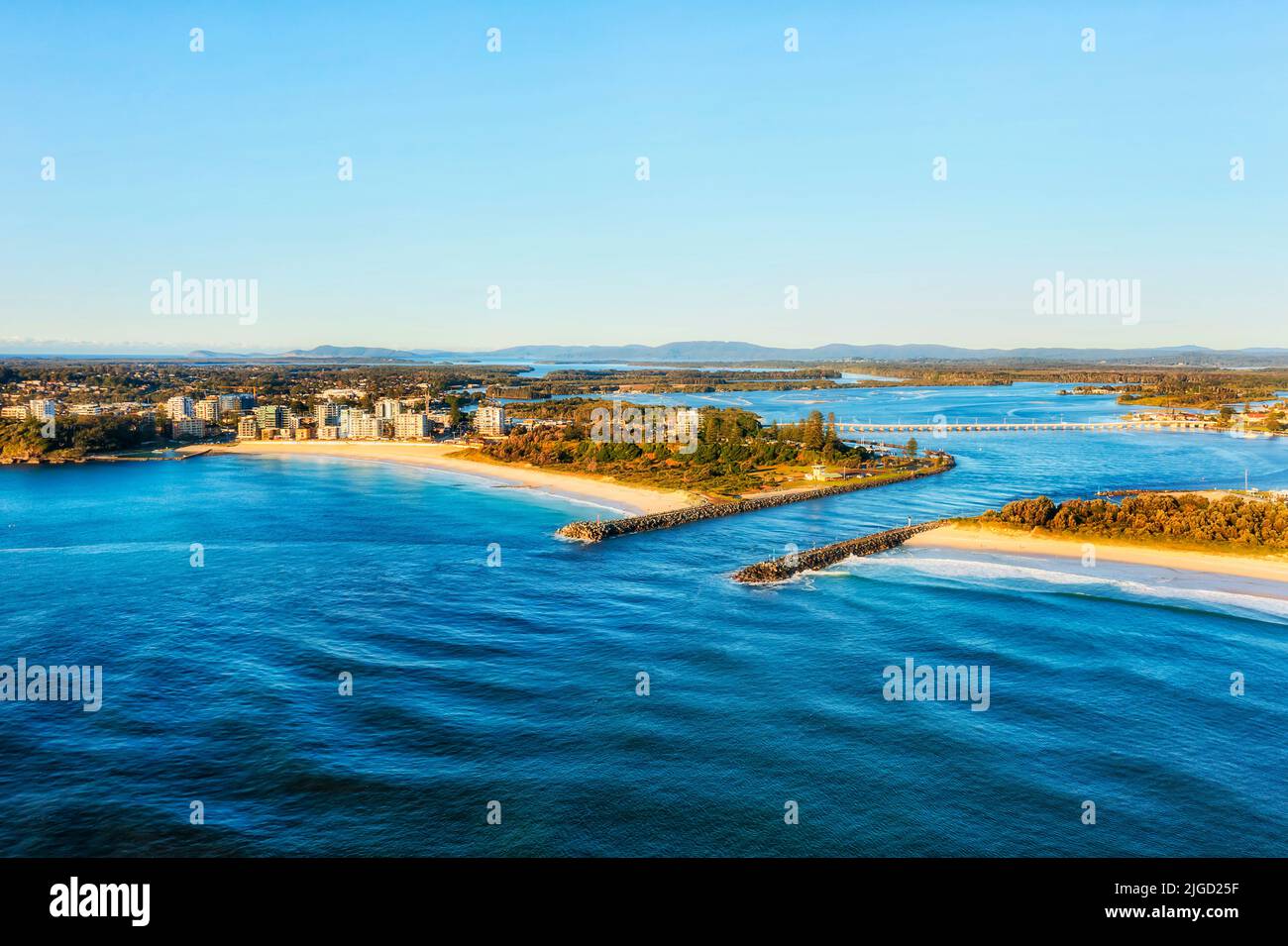 Waterfront of Forster Tuncurry double town settlement on Wallis lake at the delta of Coolongolook river entering Pacific ocean in Australia - aerial l Stock Photo