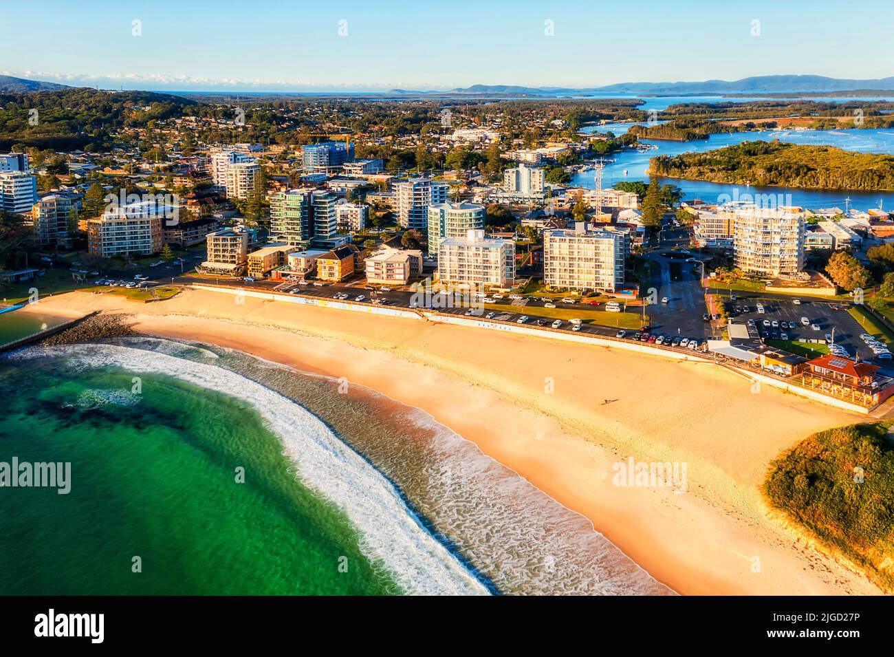 Forster sandy beach with emerald water of Pacific ocean and rock pool at Forster town waterfront in Australia - aerial townscape. Stock Photo