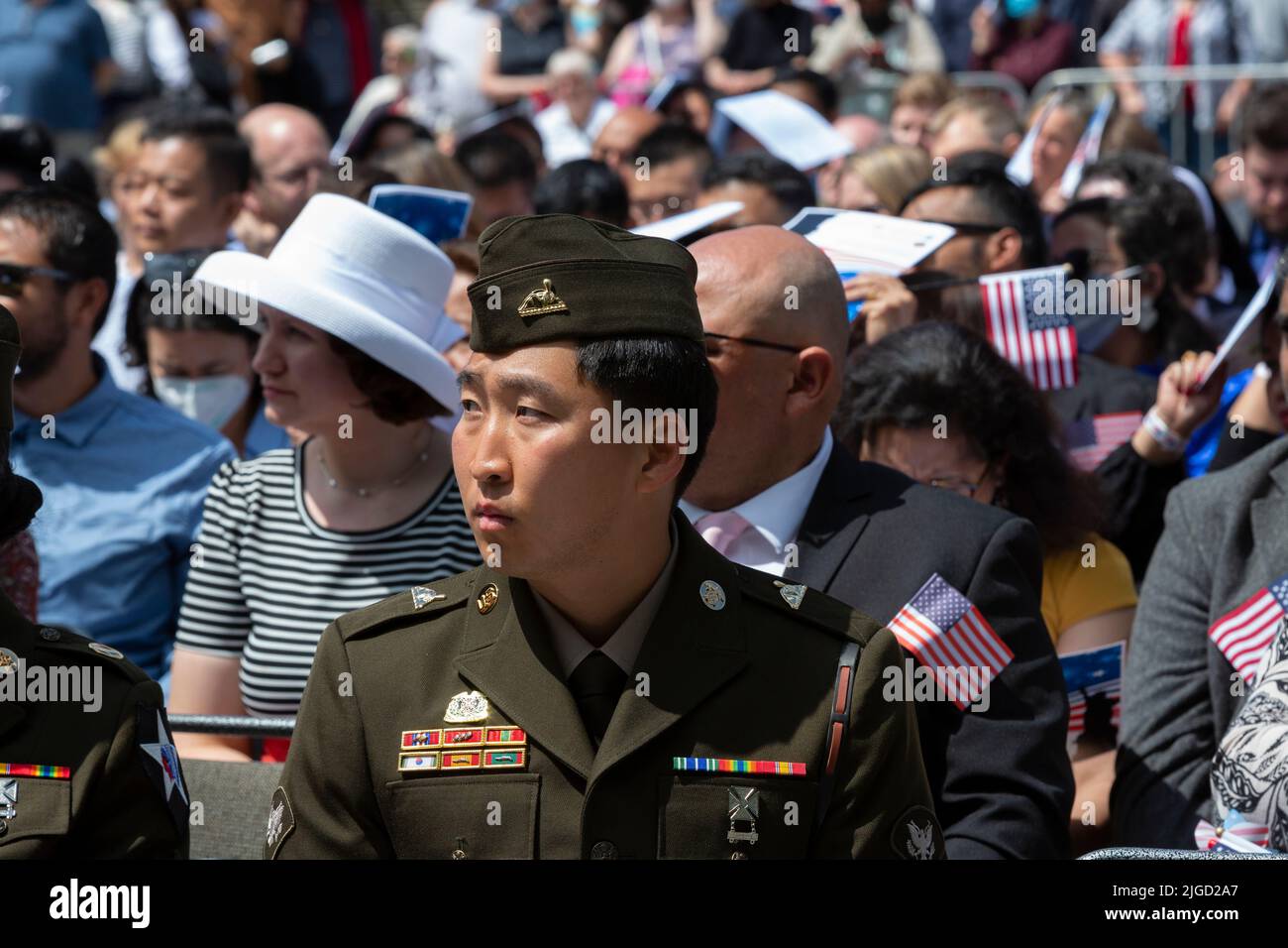 Members of the U.s. military and candidates for U.S. citizenship prepare to be sworn in at a naturalization ceremony at Fisher Pavilion in Seattle on Stock Photo