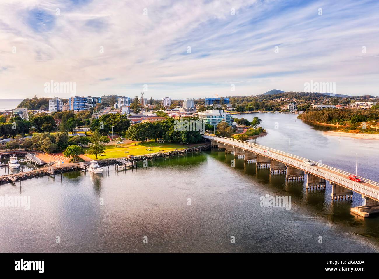 Marina, harbour and bridge across Coolongolook river to Forster town on Australian Pacific Mid North coast - aerial view. Stock Photo
