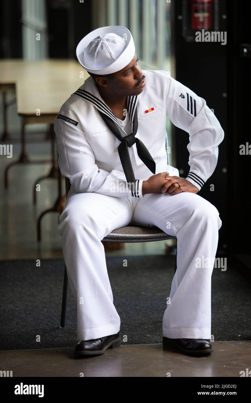 A member of the Navy Band Northwest watches as candidates for U.S. citizenship are sworn in during a naturalization ceremony a naturalization ceremony Stock Photo