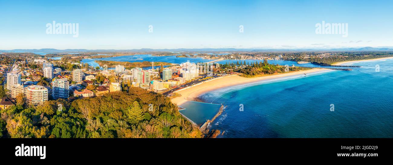 Green park on Second head to Nine Mile beach over Forstrer beach and river mouth in aerial panorama of Forster Tuncurry towns, Australia. Stock Photo