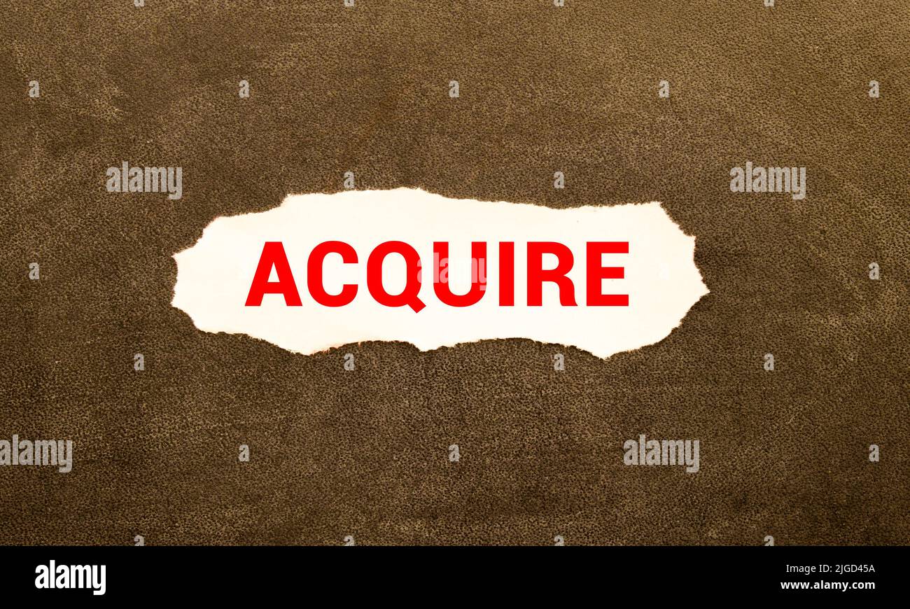 word Acquire on wooden block. Stock Photo