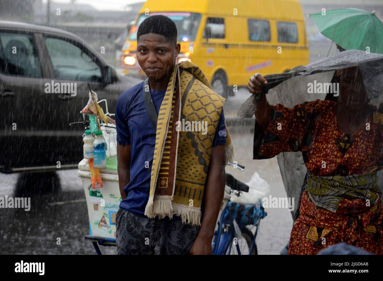 Lagos, Nigeria, 9th July, 2022 A man looks as Muslim faithful, despite the heavy rainfall, pray to mark the 2022 Eid-el-Kabir festival at Ikeja Along in Lagos, Nigeria, on Saturday July 9, 2022. Photo by Adekunle Ajayi Credit: Adekunle Ajayi/Alamy Live News Stock Photo