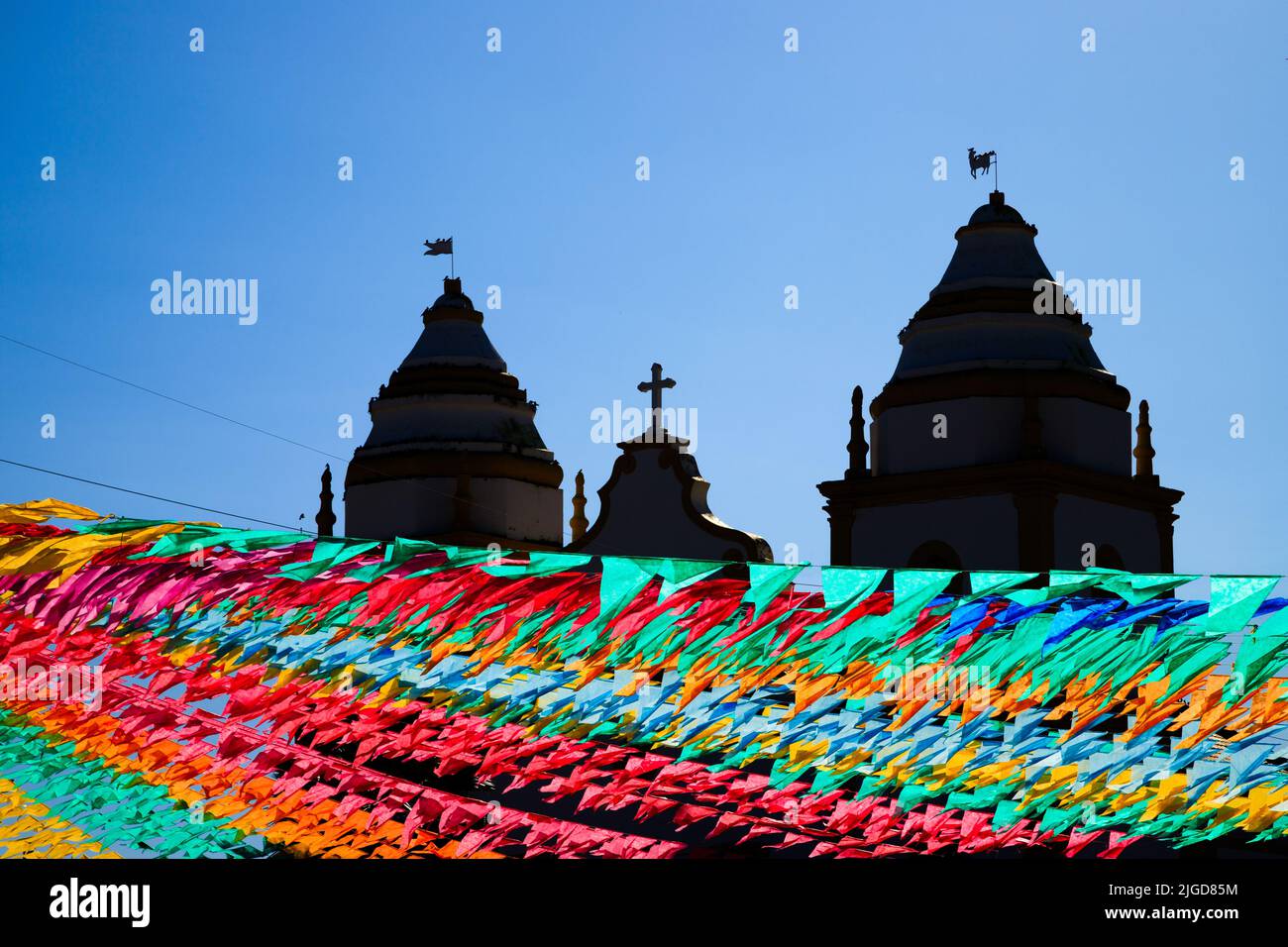 church in silhouette with decorative colorful flags of festa junina in brazil Stock Photo