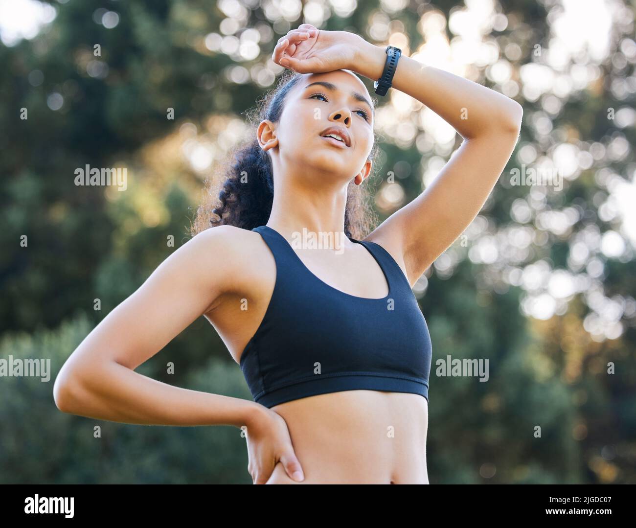 Getting her glow on. a sporty young woman catching her breath while