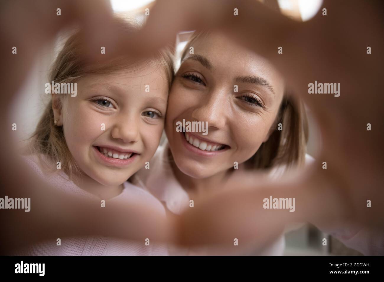 Joyful happy mom and pretty daughter kid with toothy smile Stock Photo
