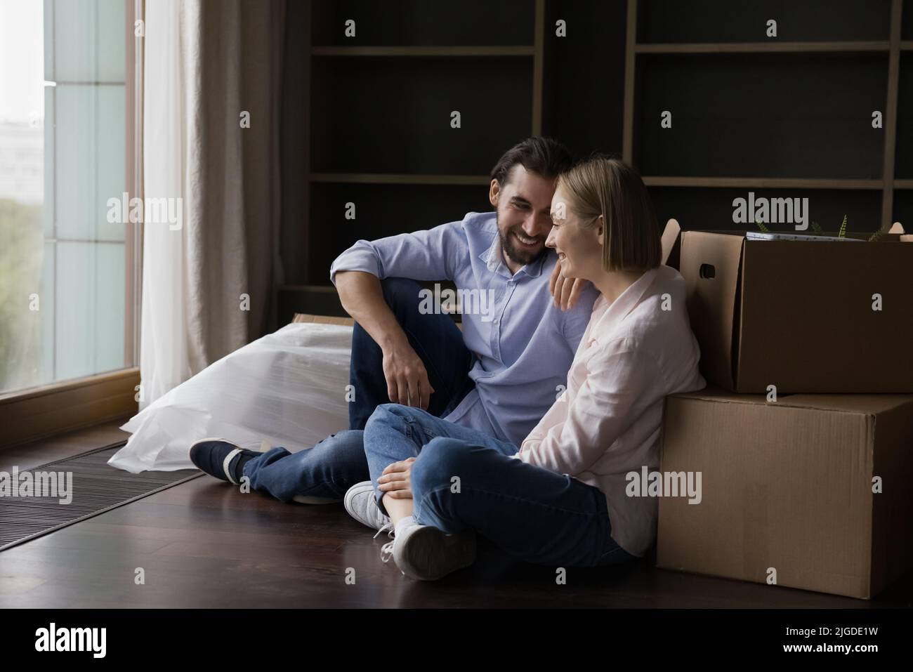 Joyful happy young couple taking break at paper boxes Stock Photo