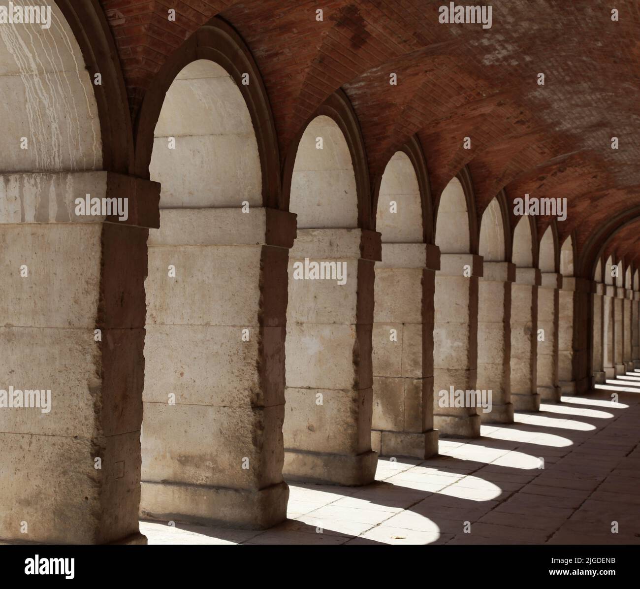 Stone archways at Aranjeuz Palace Spain Stock Photo
