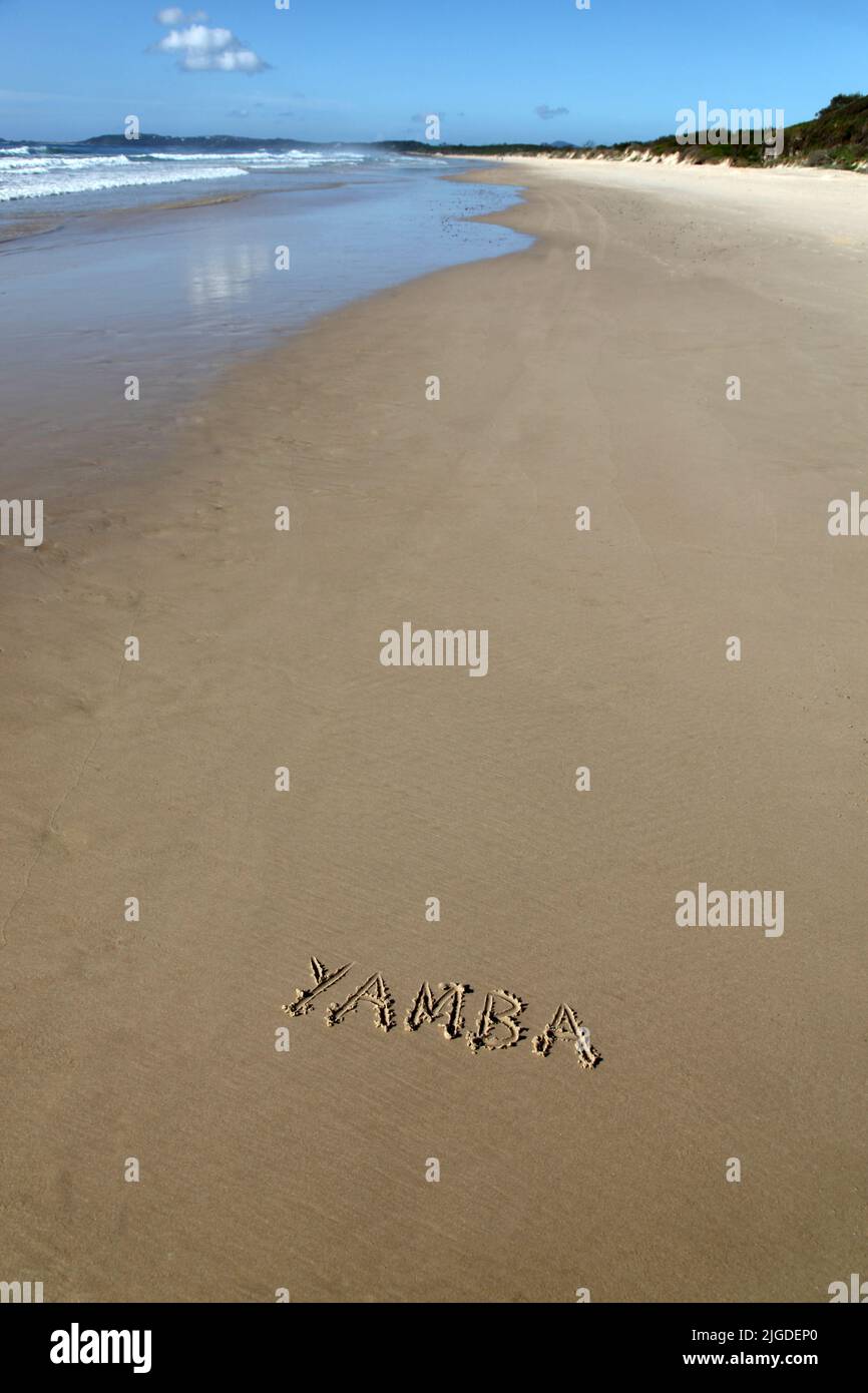 Yamba written in the sand at the beach. Yamba is a popular beachside