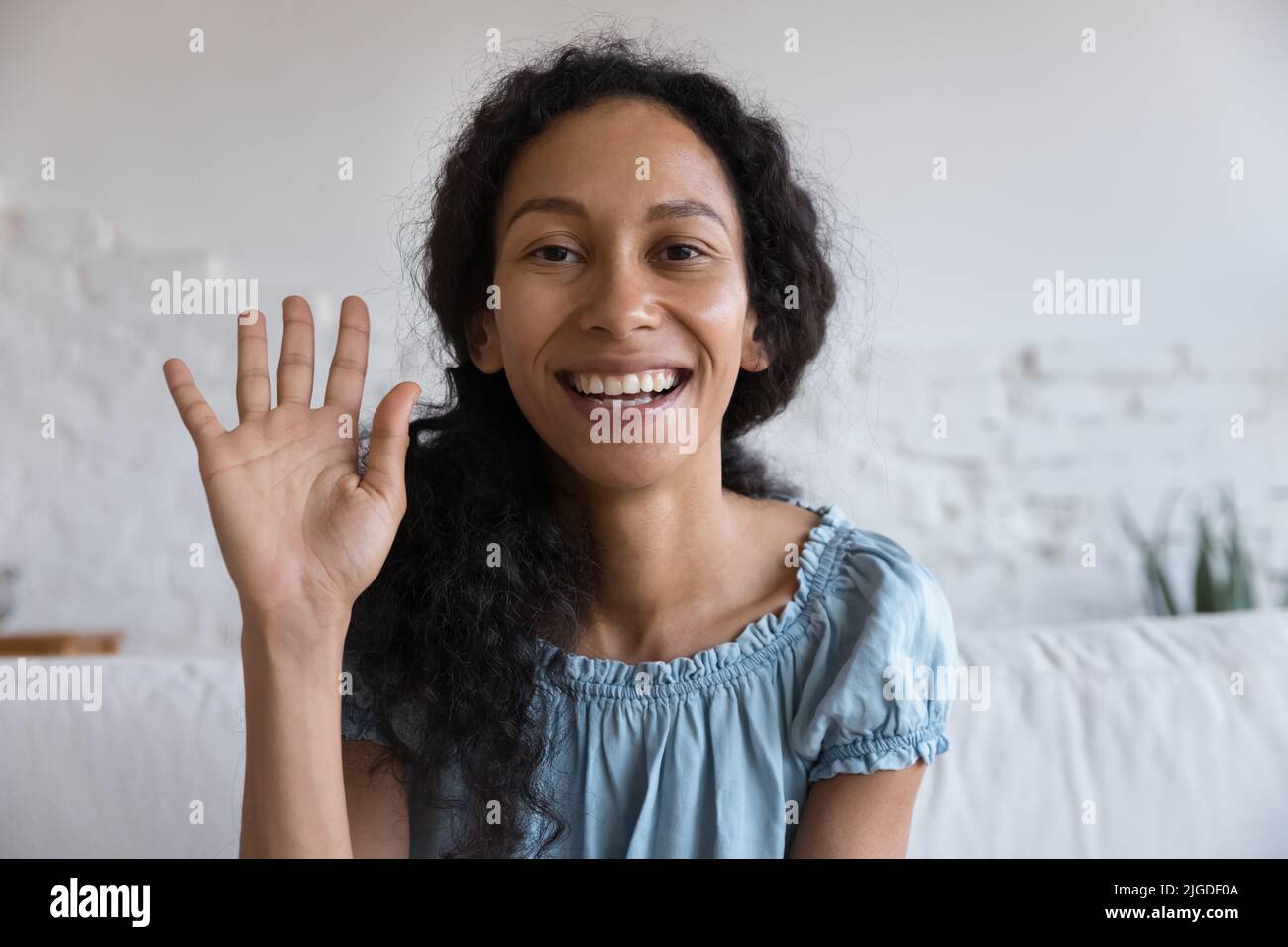 African woman smile looks at camera make video call Stock Photo