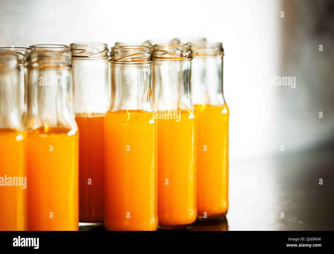 Fresh orange juice in small glass bottles, group of fresh orange juice