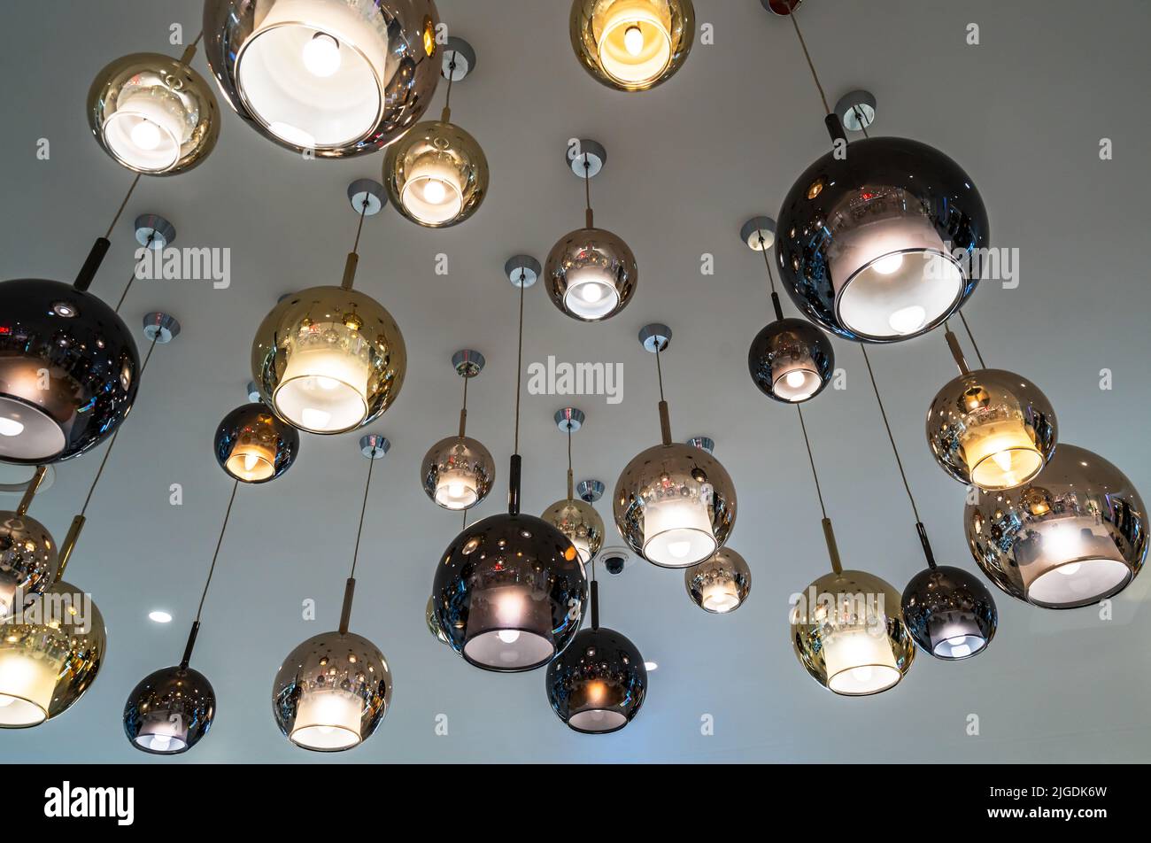 Modern hanging ceiling lights or ceiling lamps combined with cool grey background Stock Photo