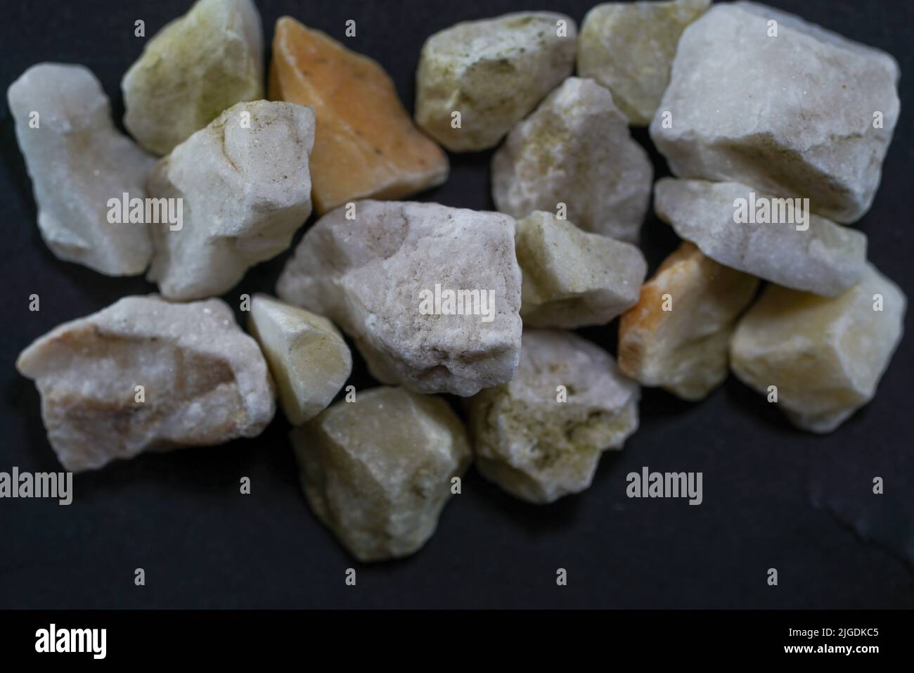 Granites are coarsely crystalline plutonic rocks rich in quartz and feldspar, but also contain dark minerals, Stock Photo