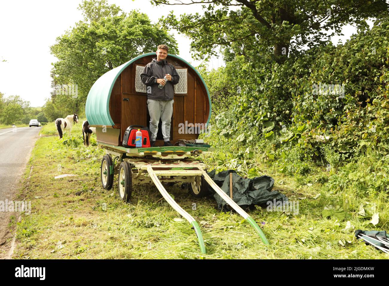 A young man with his gypsy caravan camping on the verge near Appleby Horse Fair, Appleby in Westmorland, Cumbria Stock Photo