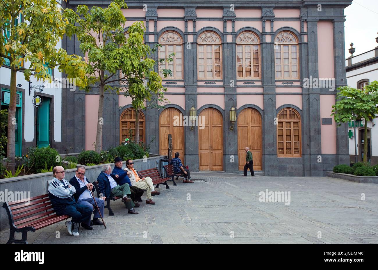 Eldery people on benches at Placa de la Constitucion, Arucas, Grand Canary, Canary islands, Spain, Europe Stock Photo