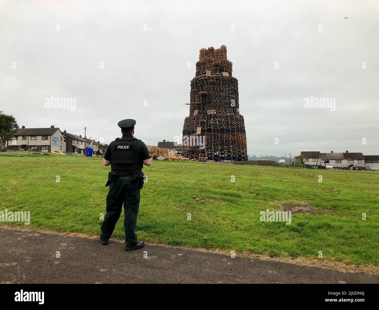 The scene where a man died after falling from a bonfire on the Antiville estate in Larne, Co Antrim last night. Police and ambulance personnel attended the scene after the fatal incident, which happened just after 9.30pm. Police remained at scene this morning. Picture date: Sunday July 10, 2022. Stock Photo