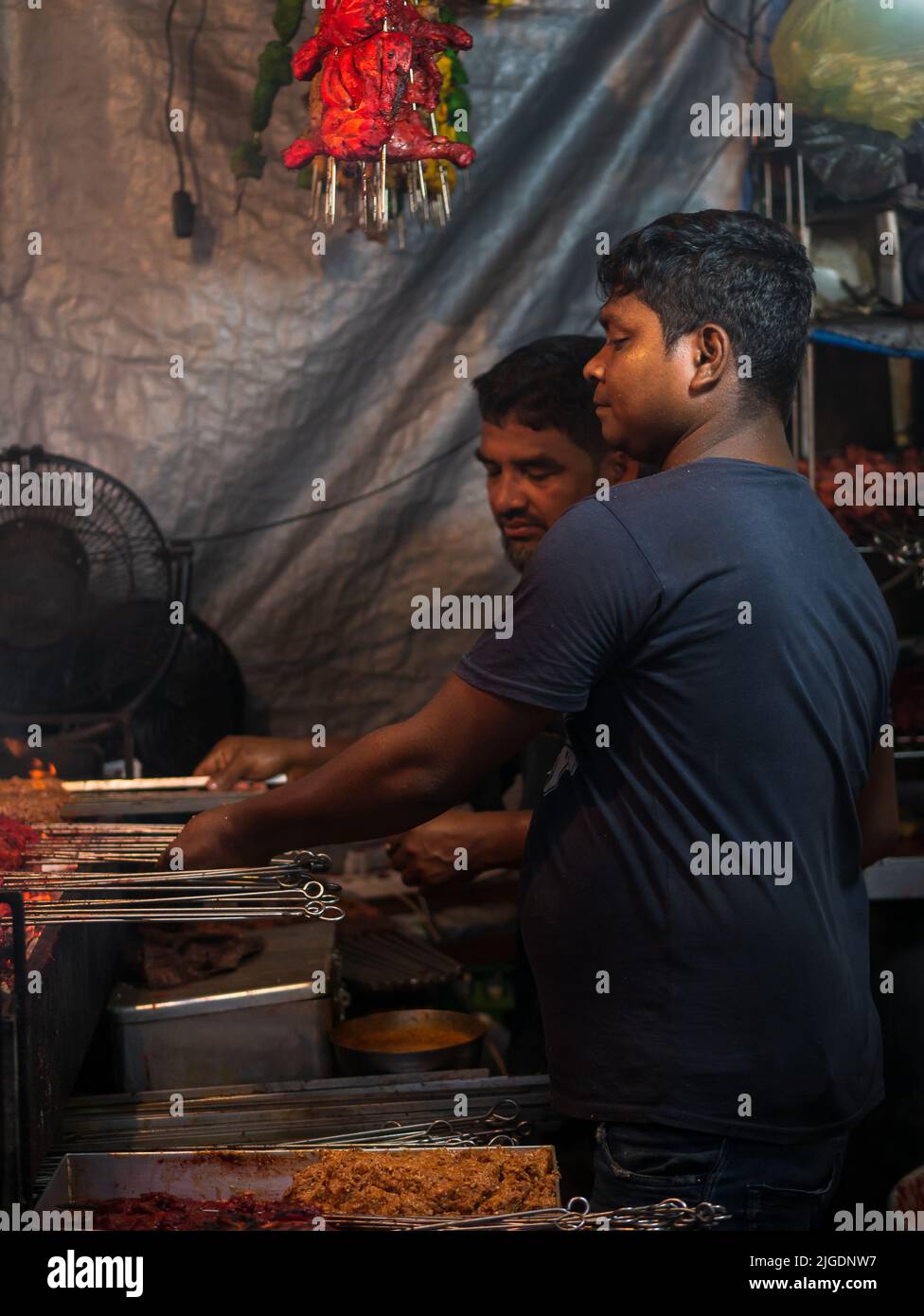Mumbai, India May 1, 2022 Muslim male vendor cooking selling halal