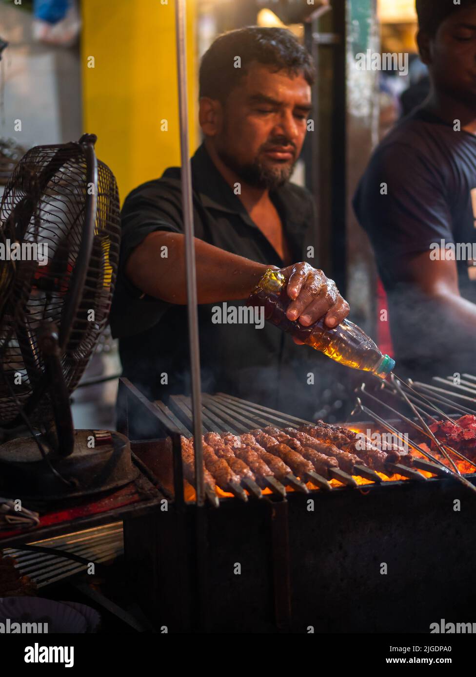 Mumbai, India May 1, 2022 Muslim male vendor cooking selling halal