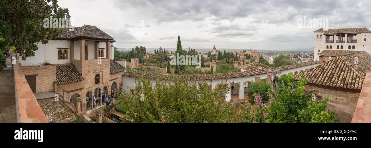 Alhambra Granada Spain - 09 14 2021: Panoramic view at the Garden Water Channel, or Patio de la Acequia, Generalife Gardens, Alhambra citadel as backg Stock Photo