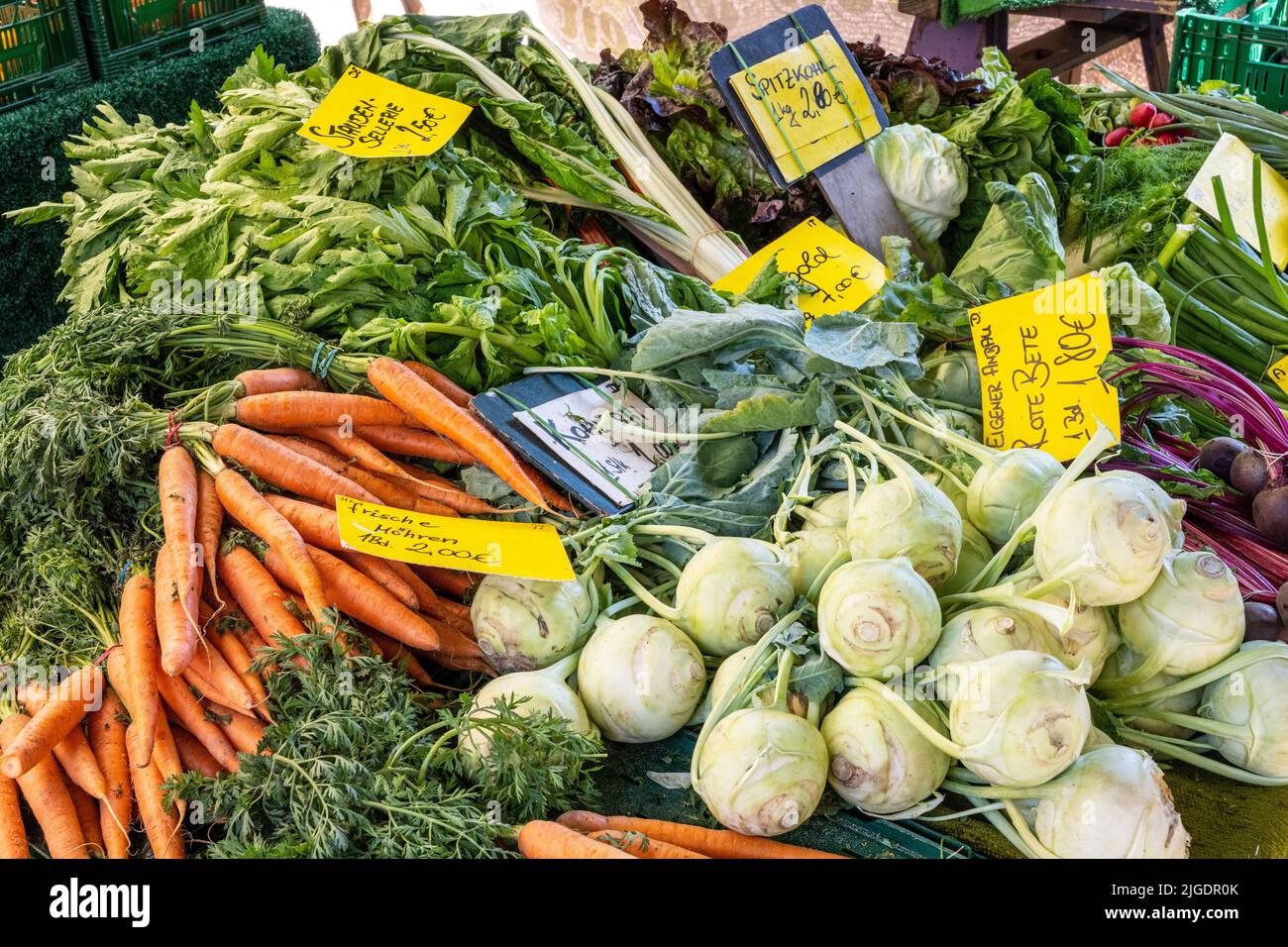 Kohlrabi, carrots and other vegetables for sale at a market Stock Photo
