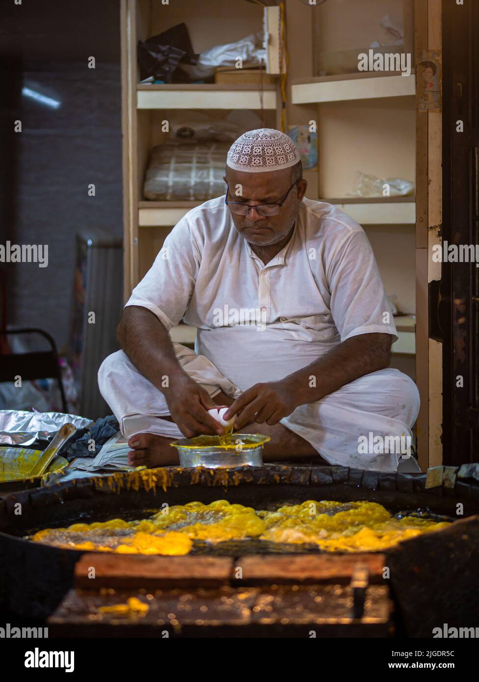 Mumbai, India May 1, 2022 Muslim male vendor cooking selling halal
