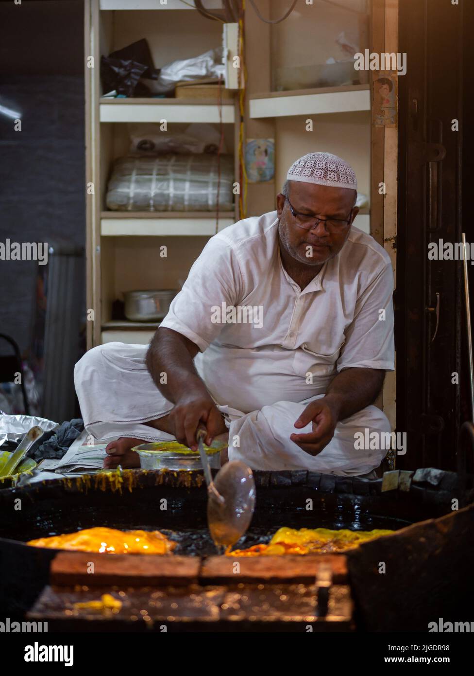 Mumbai, India May 1, 2022 Muslim male vendor cooking selling halal