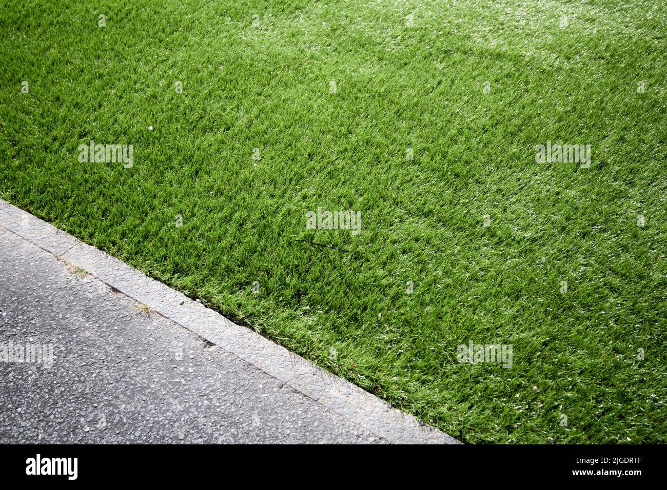 laying artificial grass in a garden in the uk Stock Photo